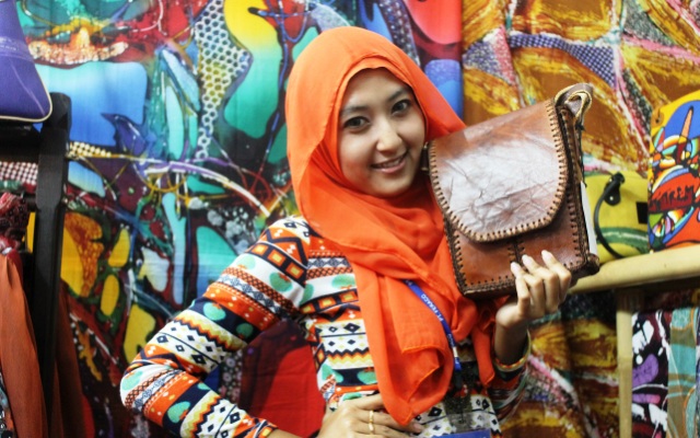 Putri sedang bergaya bersama tas produk home industri yang dipimpin Ayahnya di stan pameran kuliner Nusantara di gedung JEC Jogjakarta (Foto Tarmizi Age) Putri sedang bergaya bersama tas produk home industri yang dipimpin Ayahnya di stan pameran kuliner Nusantara di gedung JEC Jogjakarta (Foto Tarmizi Age)